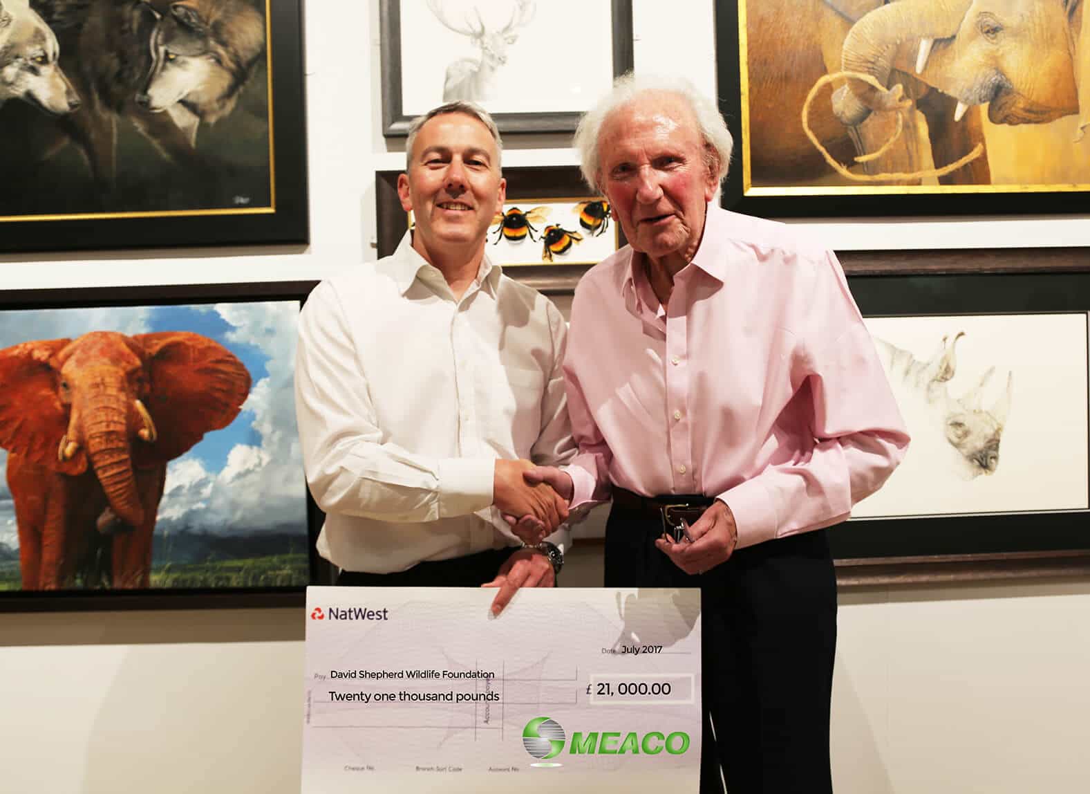 Chris Michael director of Meaco with David Shepherd CBE holding cheque