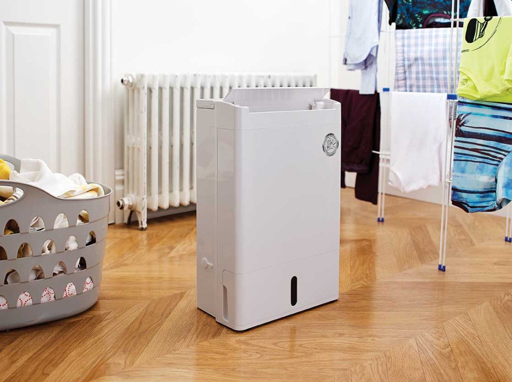A dehumidifier helps to dry laundry in a home
