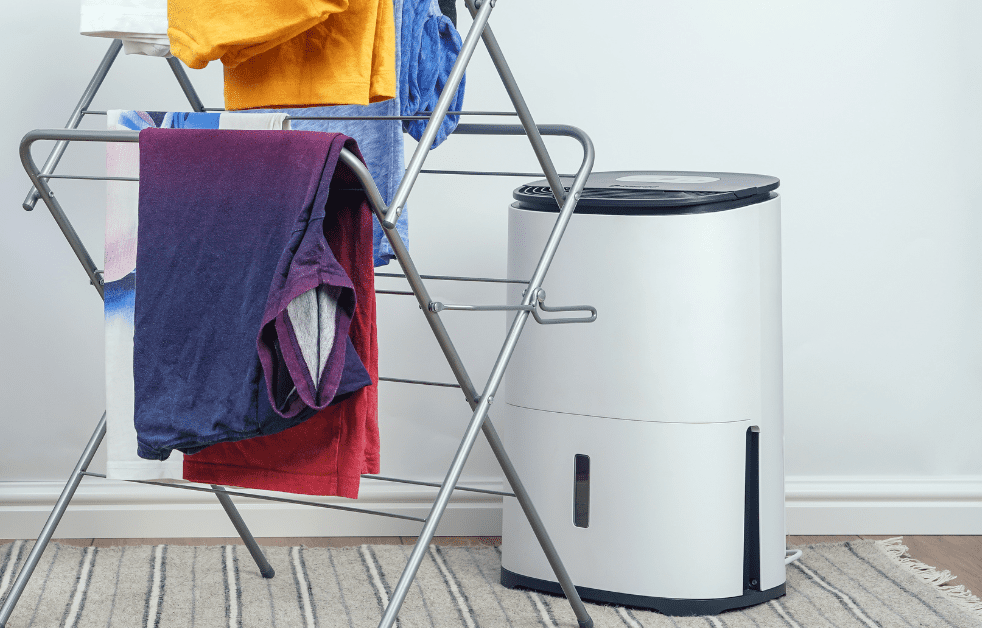Laundry drying on a rack with a dehumidifier