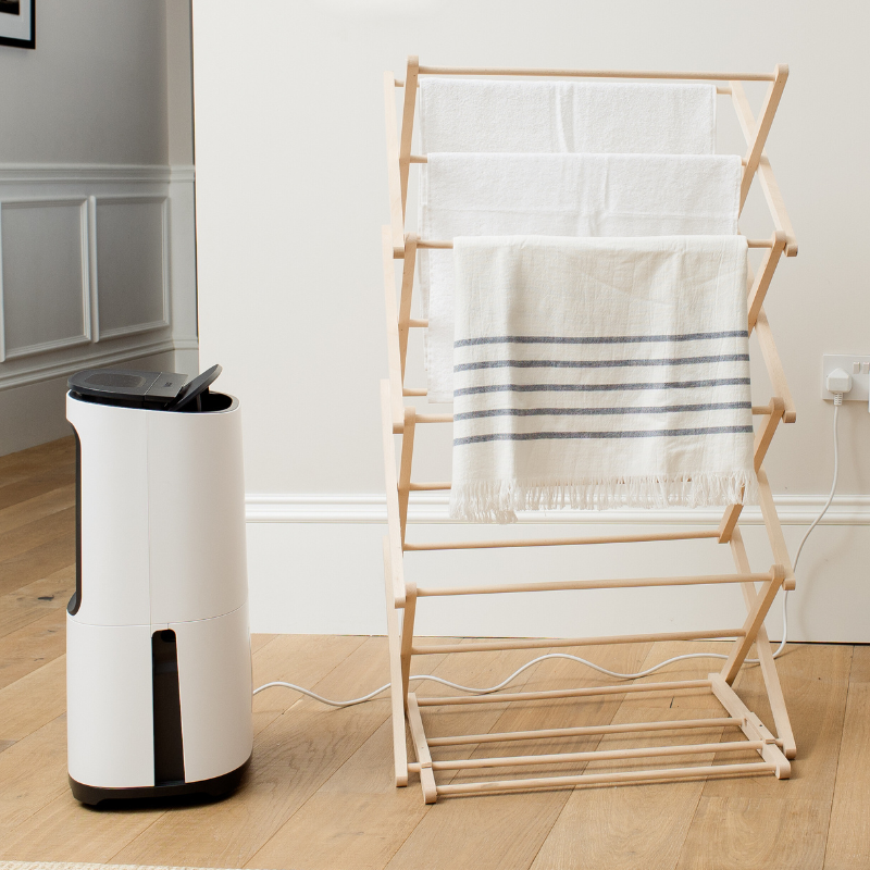 MeacoDry Arete Two Dehumidifier drying laundry indoors in a pastel beige