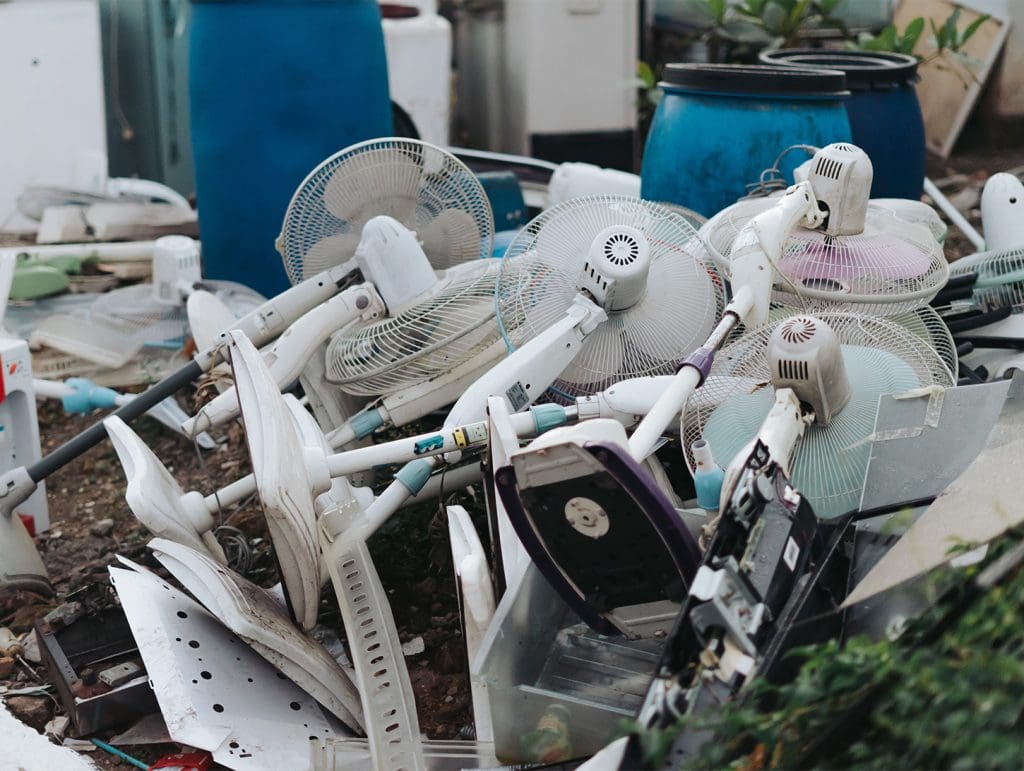 Landfill showing disposed fans and other electronics