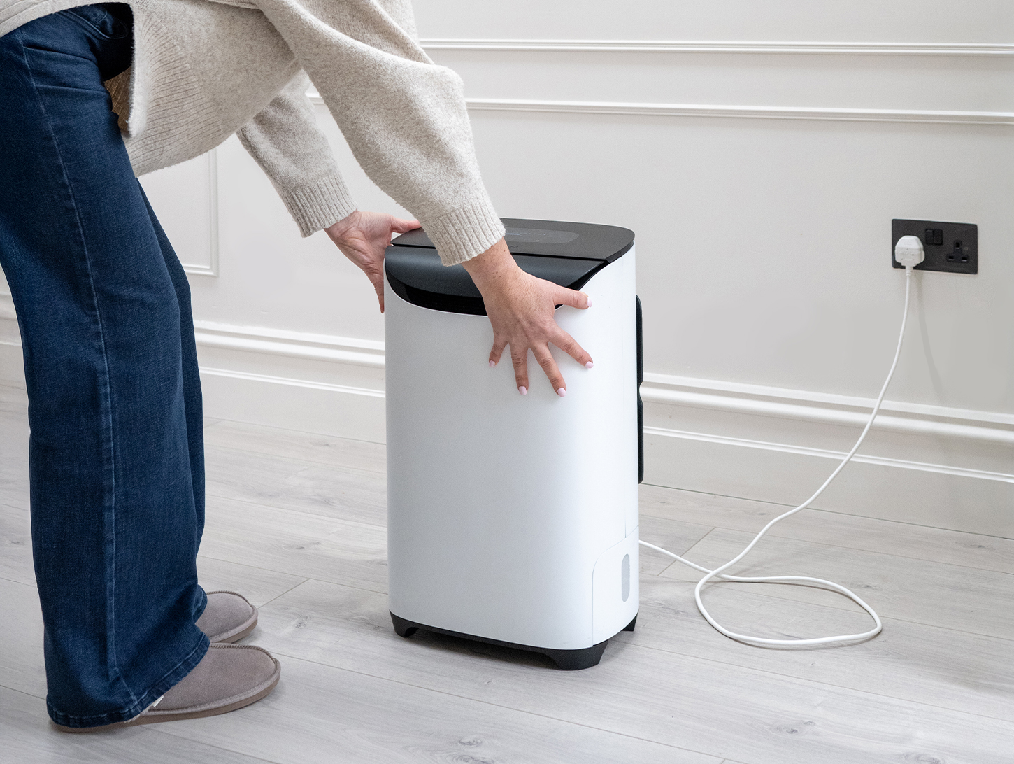 Meaco DD8L Pro Desiccant Dehumidifier womans hands in beautiful room